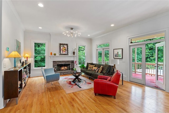 453 Carter Ave SE, Atlanta, GA 30317 - living area featuring ornamental molding, light wood-style floors, recessed lighting, a chandelier, and a stone fireplace