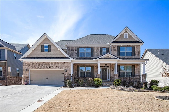 craftsman-style house featuring a garage, driveway, brick siding, and a porch