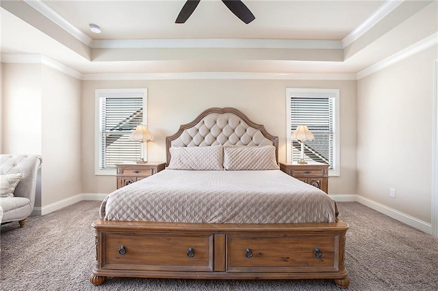 bedroom featuring carpet floors, a tray ceiling, and crown molding