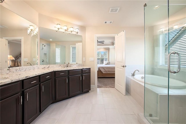 ensuite bathroom with double vanity, a stall shower, visible vents, and connected bathroom