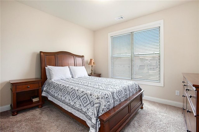 bedroom with light colored carpet, visible vents, and baseboards