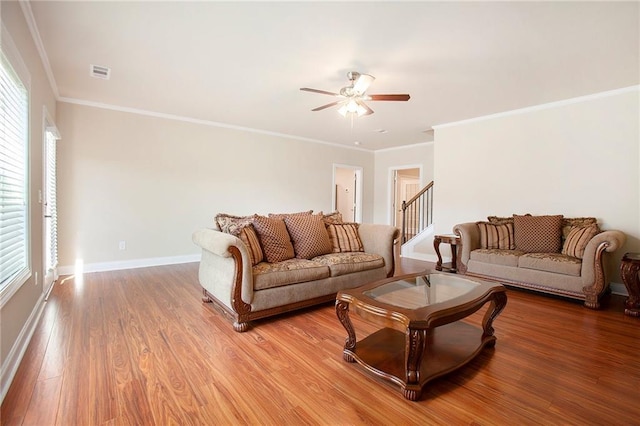 living room with visible vents, baseboards, stairs, a ceiling fan, and light wood-style floors