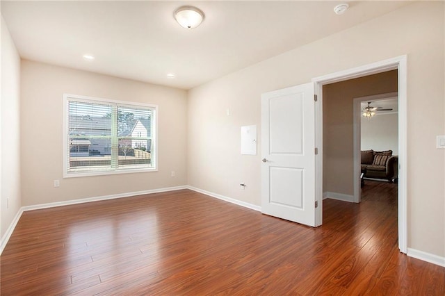 spare room featuring recessed lighting, wood finished floors, and baseboards