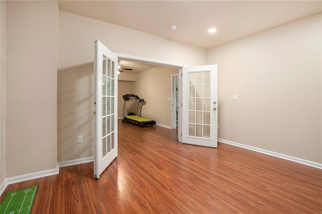 spare room with recessed lighting, french doors, baseboards, and wood finished floors