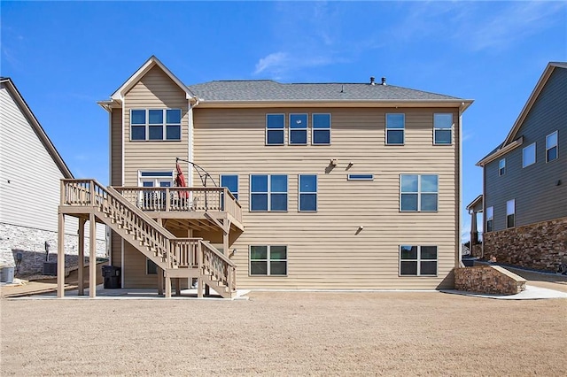 back of house featuring stairs, central AC, and a wooden deck