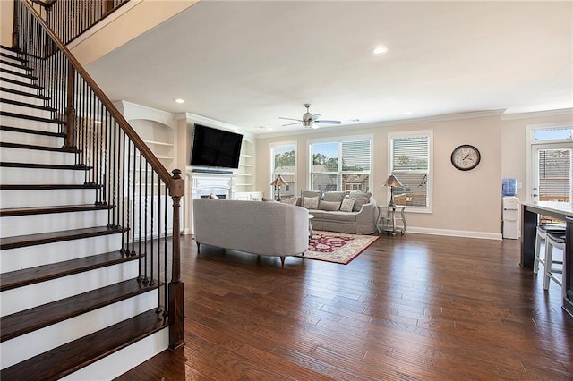 living area with dark wood-style flooring, a fireplace, and plenty of natural light