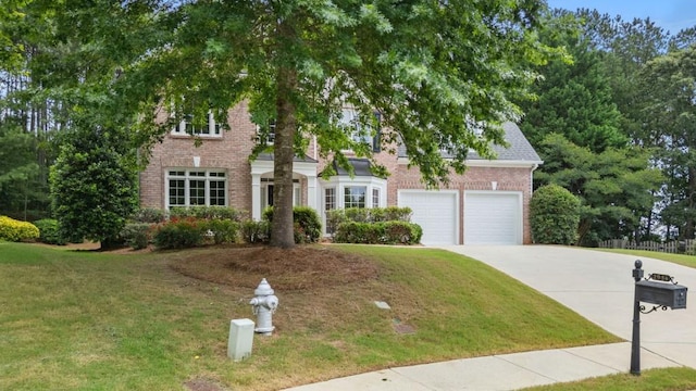 2934 Mill Grove Ter, Dacula, GA 30019 - view of front of house featuring brick siding, driveway, a front yard, and a garage