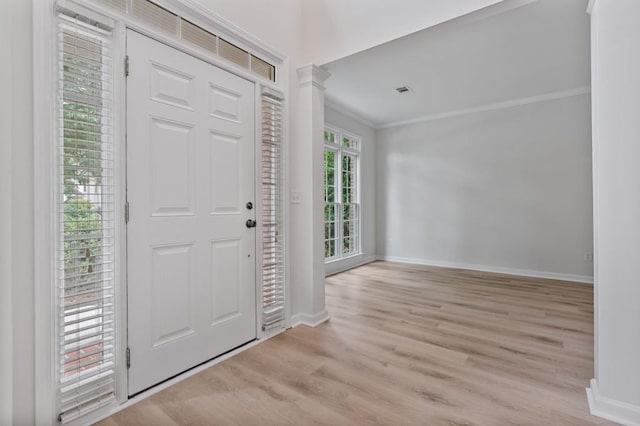 2934 Mill Grove Ter, Dacula, GA 30019 - entryway with crown molding, light wood-style floors, and decorative columns
