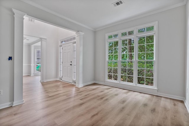 2934 Mill Grove Ter, Dacula, GA 30019 - unfurnished room with crown molding, light wood-style flooring, and decorative columns