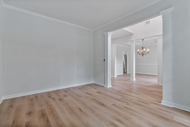 2934 Mill Grove Ter, Dacula, GA 30019 - empty room featuring decorative columns, crown molding, light wood finished floors, and a chandelier