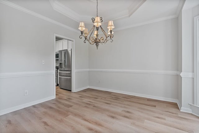 2934 Mill Grove Ter, Dacula, GA 30019 - unfurnished room featuring a tray ceiling, light wood-style floors, a chandelier, and crown molding