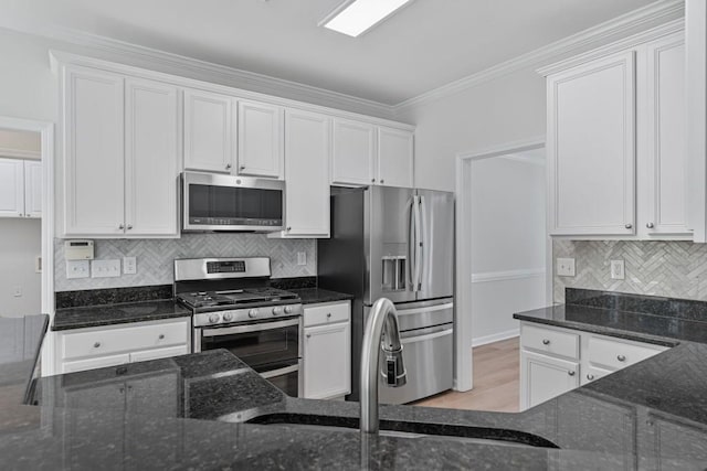 2934 Mill Grove Ter, Dacula, GA 30019 - kitchen with stainless steel appliances, white cabinetry, dark stone counters, and ornamental molding