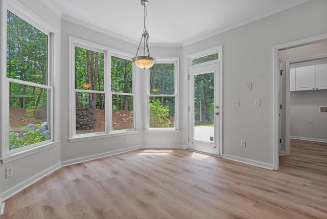 2934 Mill Grove Ter, Dacula, GA 30019 - unfurnished dining area featuring healthy amount of natural light, light wood finished floors, and ornamental molding