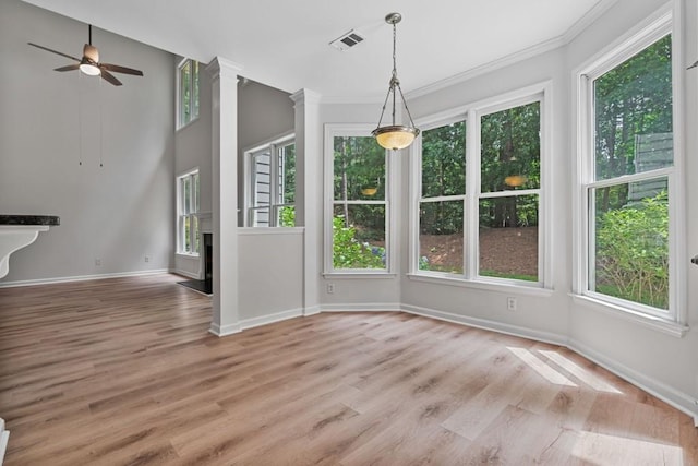 2934 Mill Grove Ter, Dacula, GA 30019 - unfurnished dining area featuring healthy amount of natural light, ornamental molding, light wood-style floors, and a ceiling fan