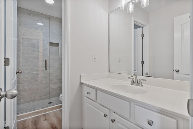 2934 Mill Grove Ter, Dacula, GA 30019 - bathroom with vanity, a shower stall, and wood finished floors