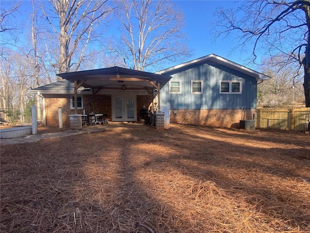 rear view of property featuring cooling unit and french doors