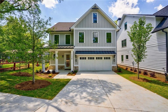 view of front of house featuring board and batten siding, a garage, concrete driveway, a standing seam roof, and covered porch