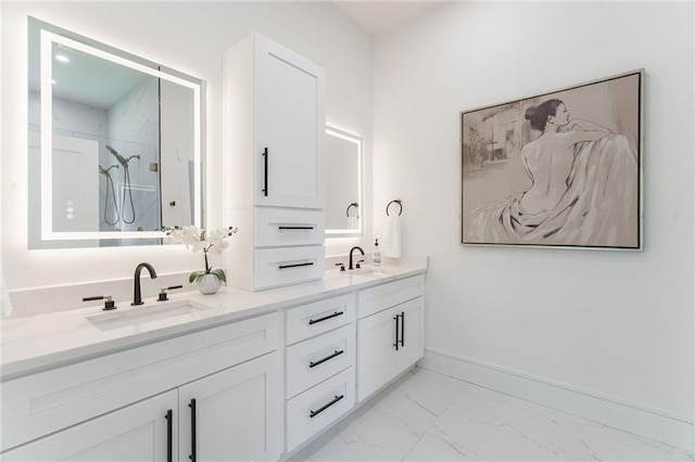 full bath with marble finish flooring, double vanity, a shower, and baseboards