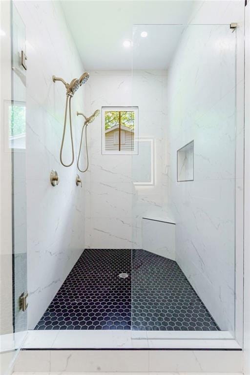 full bathroom featuring a marble finish shower