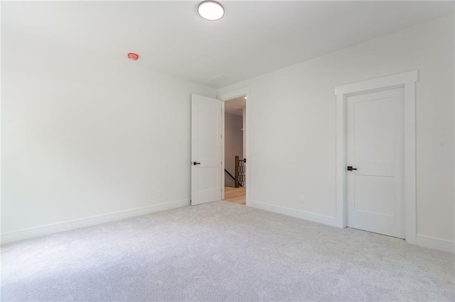 empty room with light carpet and baseboards