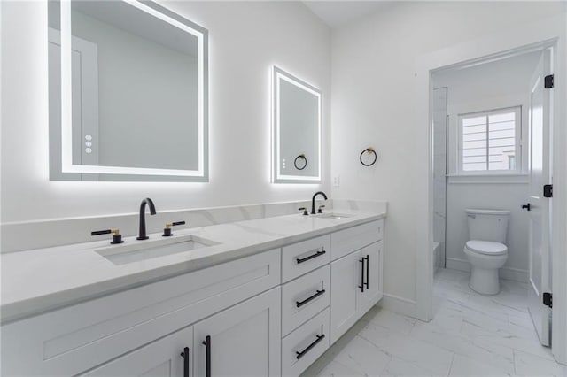 full bathroom featuring marble look tiles, double vanity, baseboards, toilet, and a bathtub