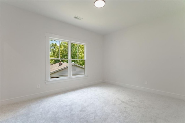 carpeted spare room with baseboards