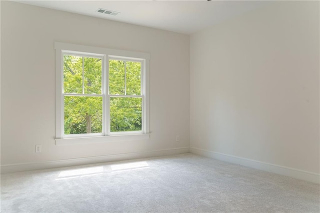 carpeted spare room with baseboards