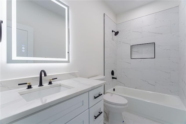 full bath with toilet, marble look tiles,  shower combination, and vanity