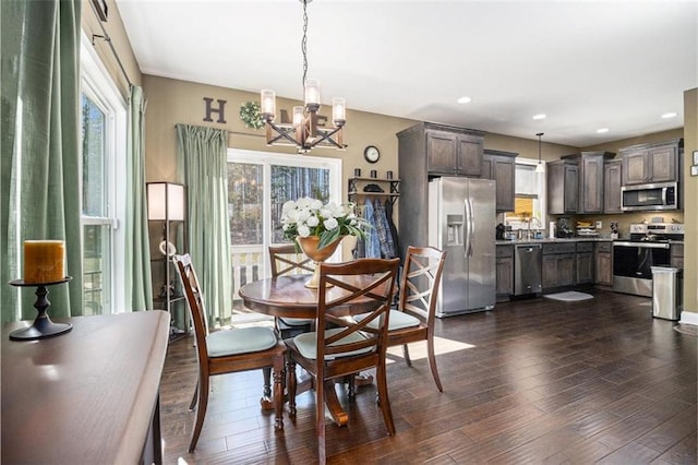 dining area featuring dark wood-type flooring, a healthy amount of sunlight, and recessed lighting