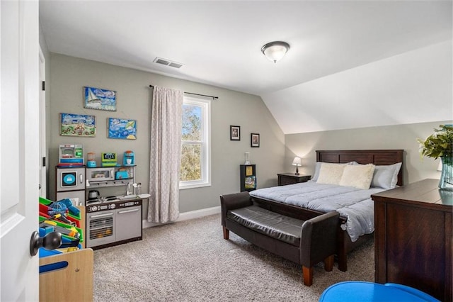 bedroom with vaulted ceiling, visible vents, light carpet, and baseboards