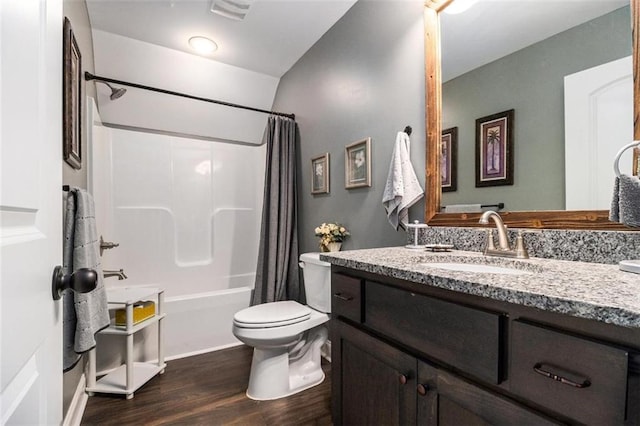 full bathroom with wood finished floors, vanity, visible vents, toilet, and shower / bath combination with curtain