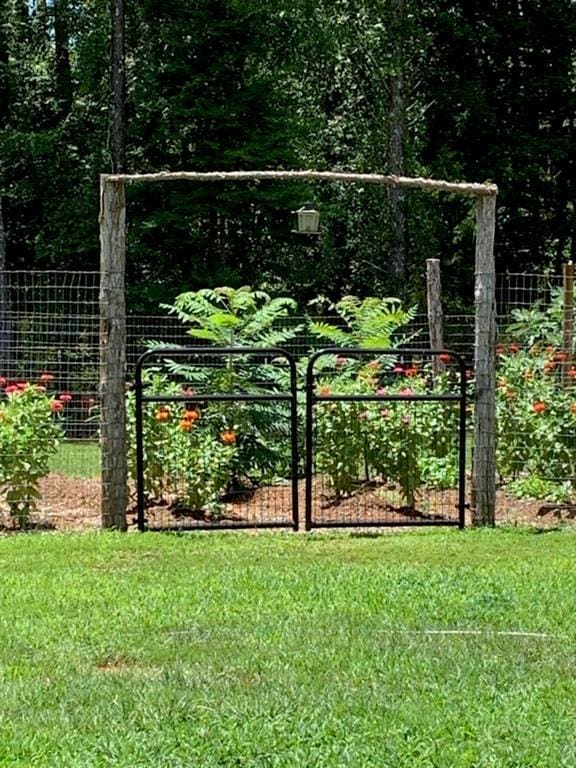 view of gate featuring a yard