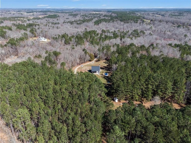 birds eye view of property with a view of trees