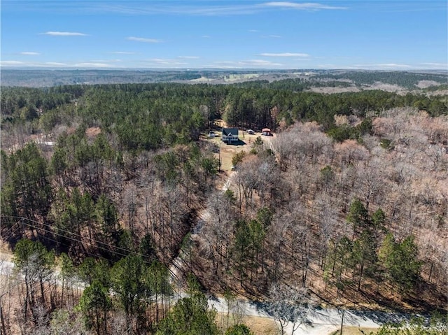 birds eye view of property featuring a view of trees