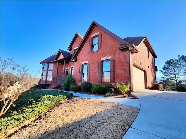 view of home's exterior with concrete driveway, brick siding, and an attached garage