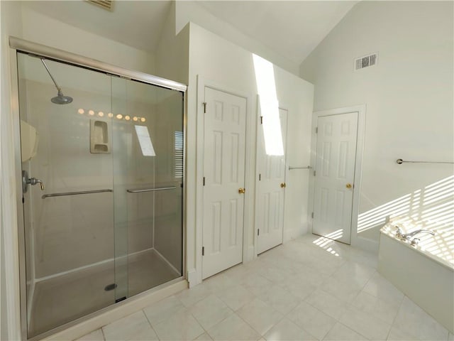 full bathroom featuring visible vents, tile patterned floors, vaulted ceiling, a shower stall, and a bath