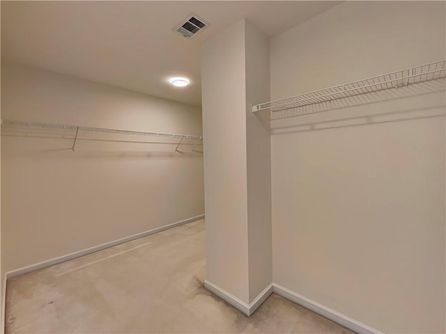 spacious closet with carpet and visible vents