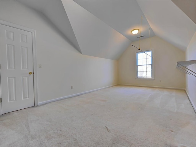 additional living space featuring carpet floors, baseboards, visible vents, and vaulted ceiling