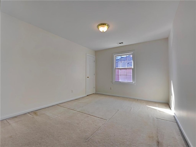 unfurnished room with baseboards, visible vents, and carpet flooring