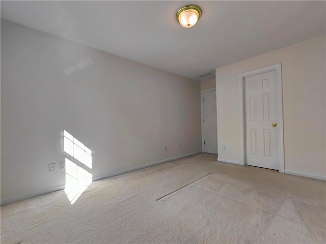 unfurnished bedroom featuring baseboards and carpet flooring