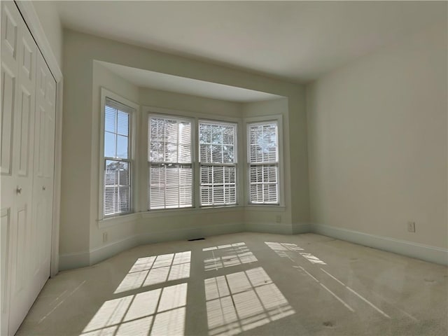 spare room with visible vents and baseboards