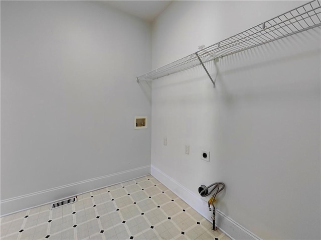 laundry room featuring light floors, hookup for a washing machine, electric dryer hookup, laundry area, and baseboards