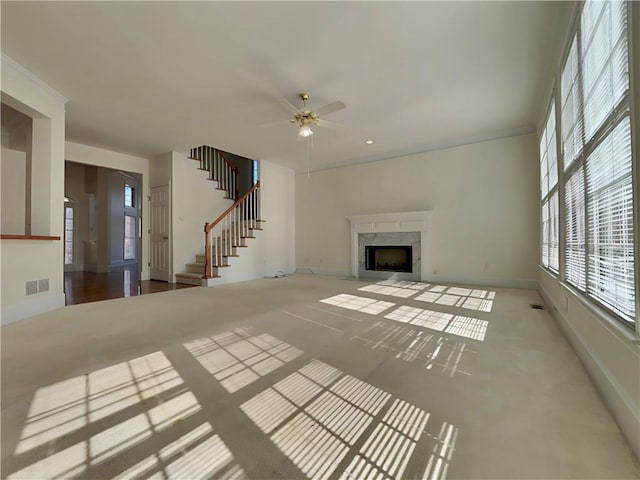 unfurnished living room featuring recessed lighting, a fireplace, visible vents, baseboards, and stairs