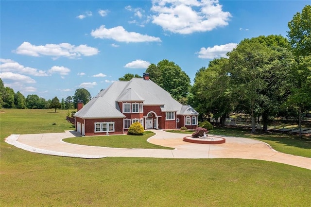 3030 Berry Rd, Loganville, GA 30052 - view of front of home featuring a chimney, curved driveway, brick siding, french doors, and a garage