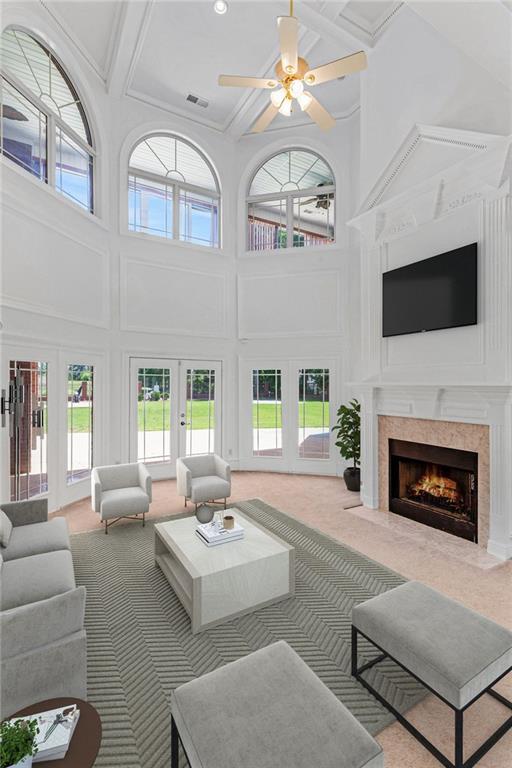 3030 Berry Rd, Loganville, GA 30052 - living area featuring coffered ceiling, a towering ceiling, french doors, plenty of natural light, and a ceiling fan