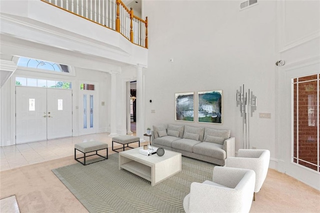 3030 Berry Rd, Loganville, GA 30052 - living area featuring a towering ceiling, carpet floors, and decorative columns