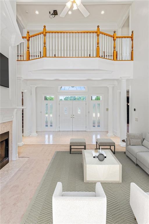 3030 Berry Rd, Loganville, GA 30052 - carpeted living room with a towering ceiling, plenty of natural light, a fireplace, recessed lighting, and ceiling fan