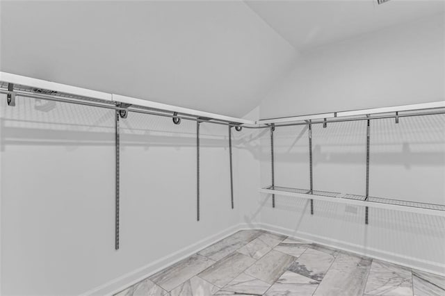 3030 Berry Rd, Loganville, GA 30052 - walk in closet featuring vaulted ceiling and light marble finish flooring