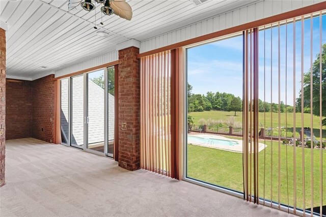 3030 Berry Rd, Loganville, GA 30052 - unfurnished sunroom with brick wall and carpet floors