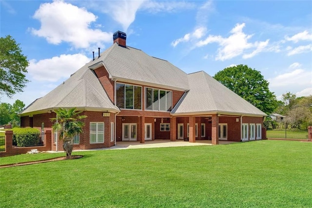 3030 Berry Rd, Loganville, GA 30052 - back of property featuring a chimney, a patio area, and brick siding